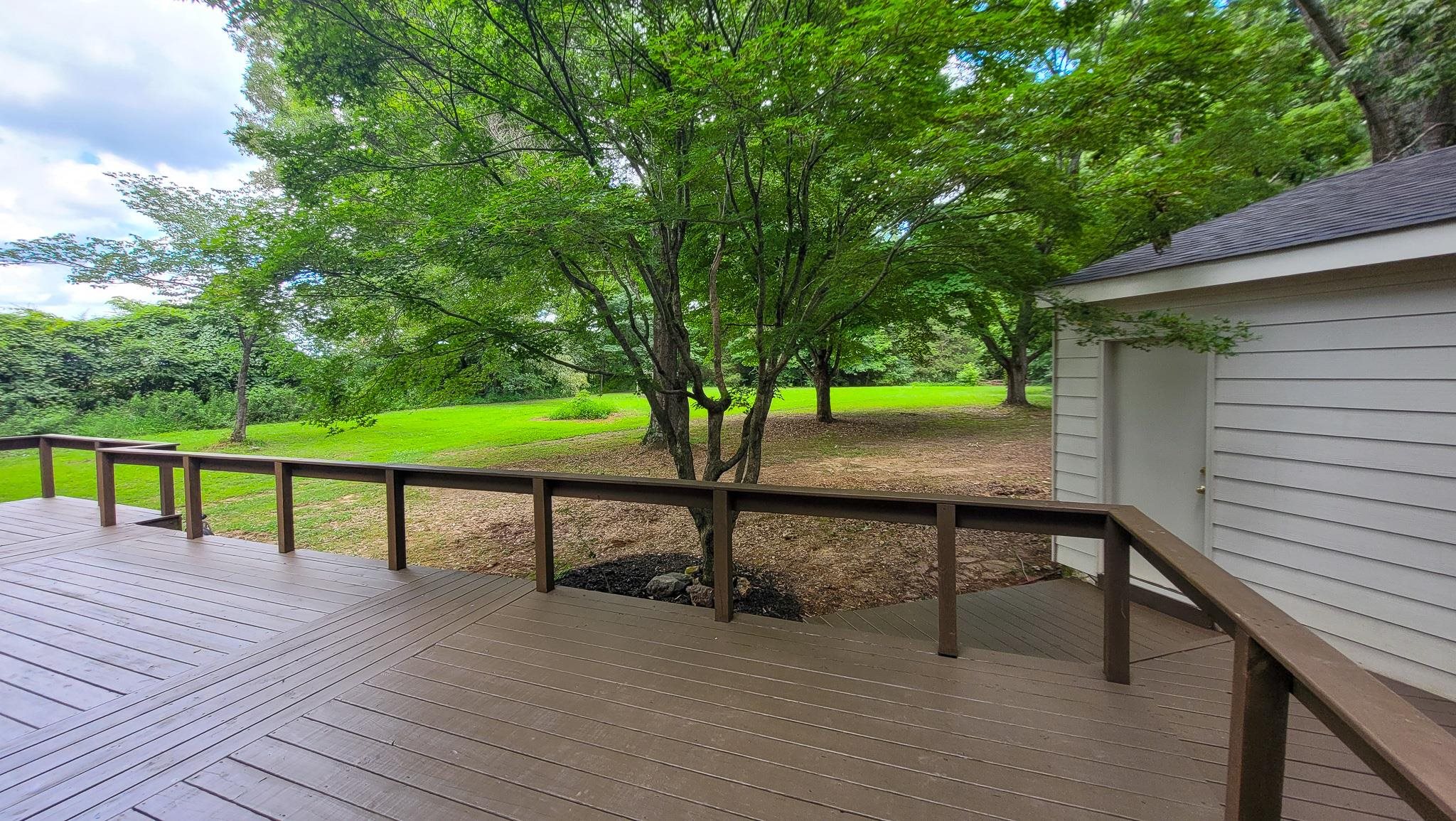 470 Rich Road Somerville, TN 38068 - Photo 9 of 40 Spacious outdoor deck with a patterned surface and wood-finish railing