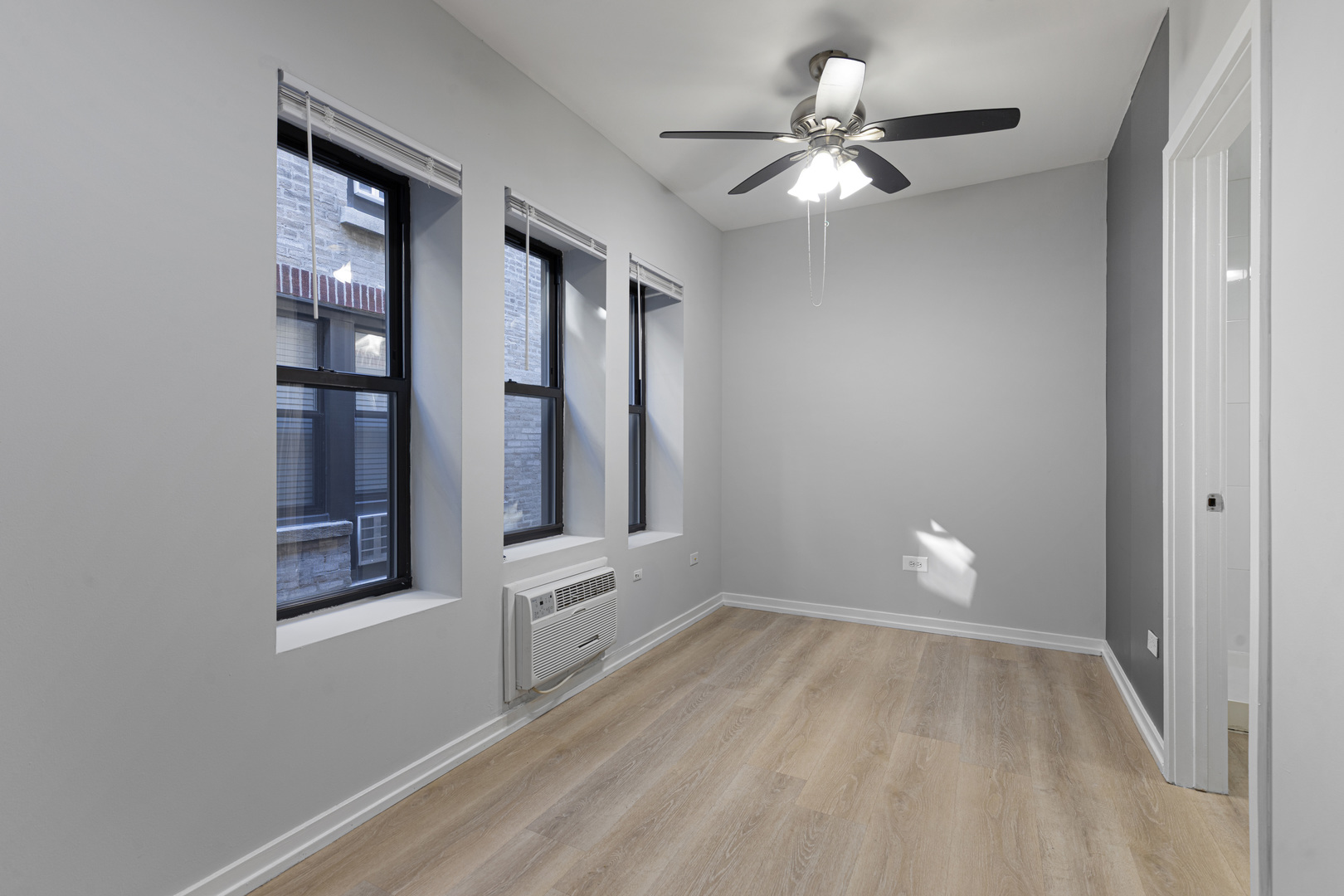 4875 North Magnolia Avenue, Unit 315 Chicago, IL 60640 - Photo 3 of 8 a view of an empty room with window and chandelier fan