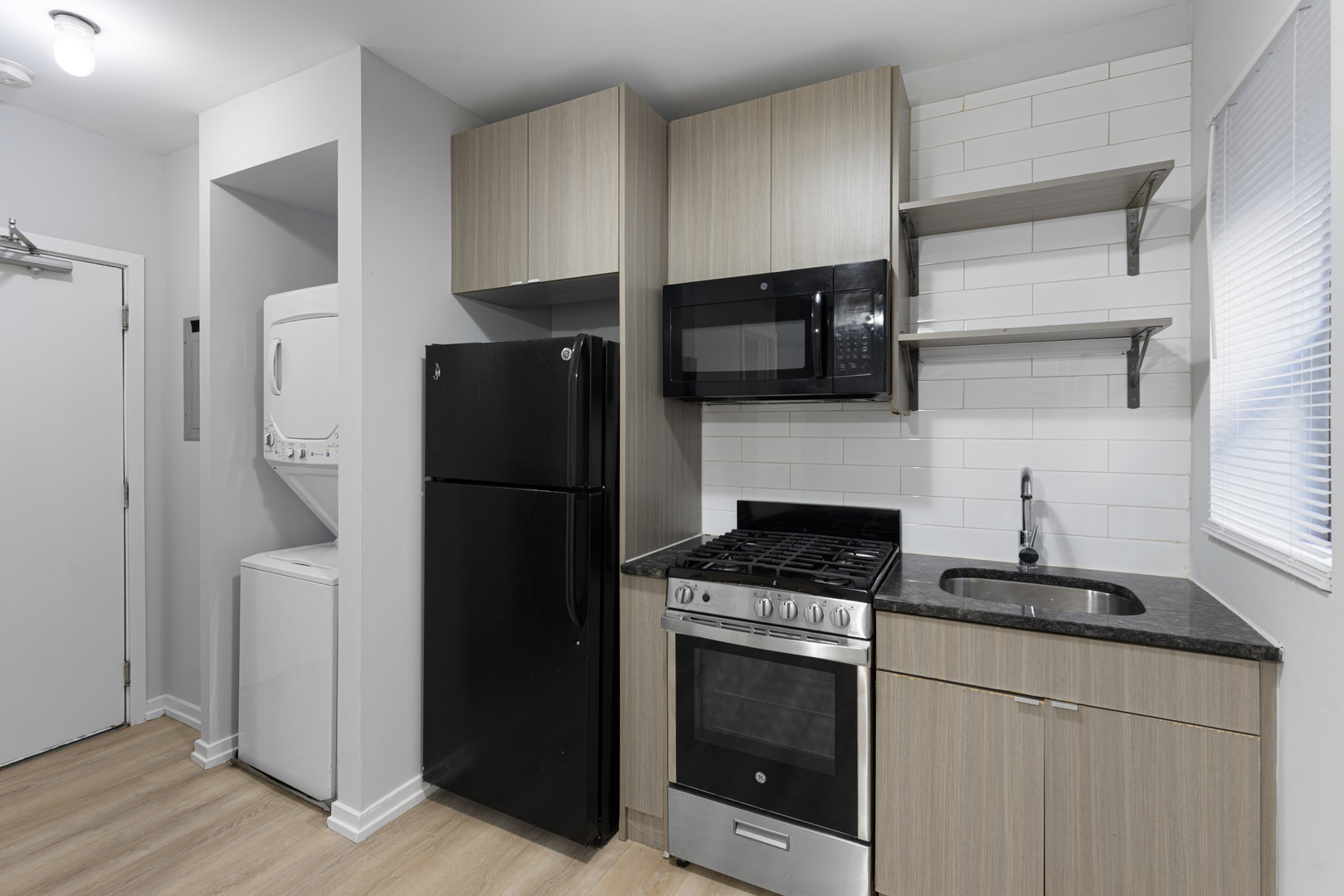 4875 North Magnolia Avenue, Unit 315 Chicago, IL 60640 - Photo 4 of 8 a kitchen with a refrigerator stove and cabinets