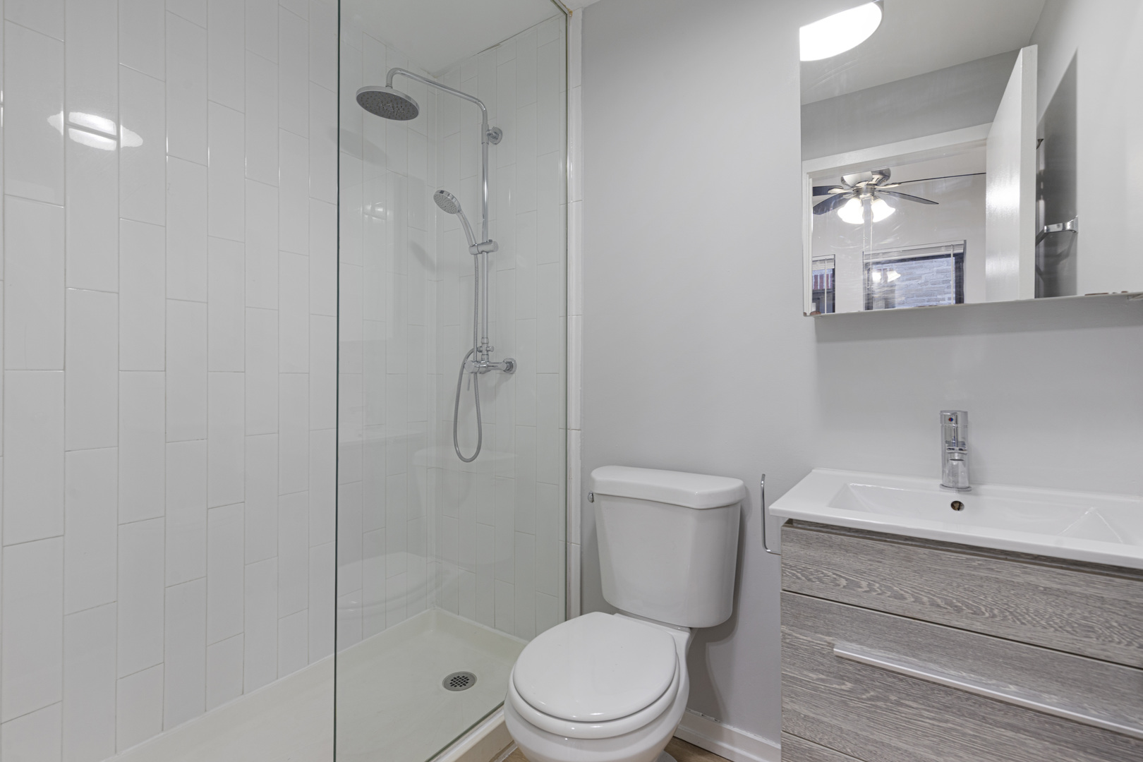 4875 North Magnolia Avenue, Unit 315 Chicago, IL 60640 - Photo 6 of 8 a bathroom with a toilet a sink and shower