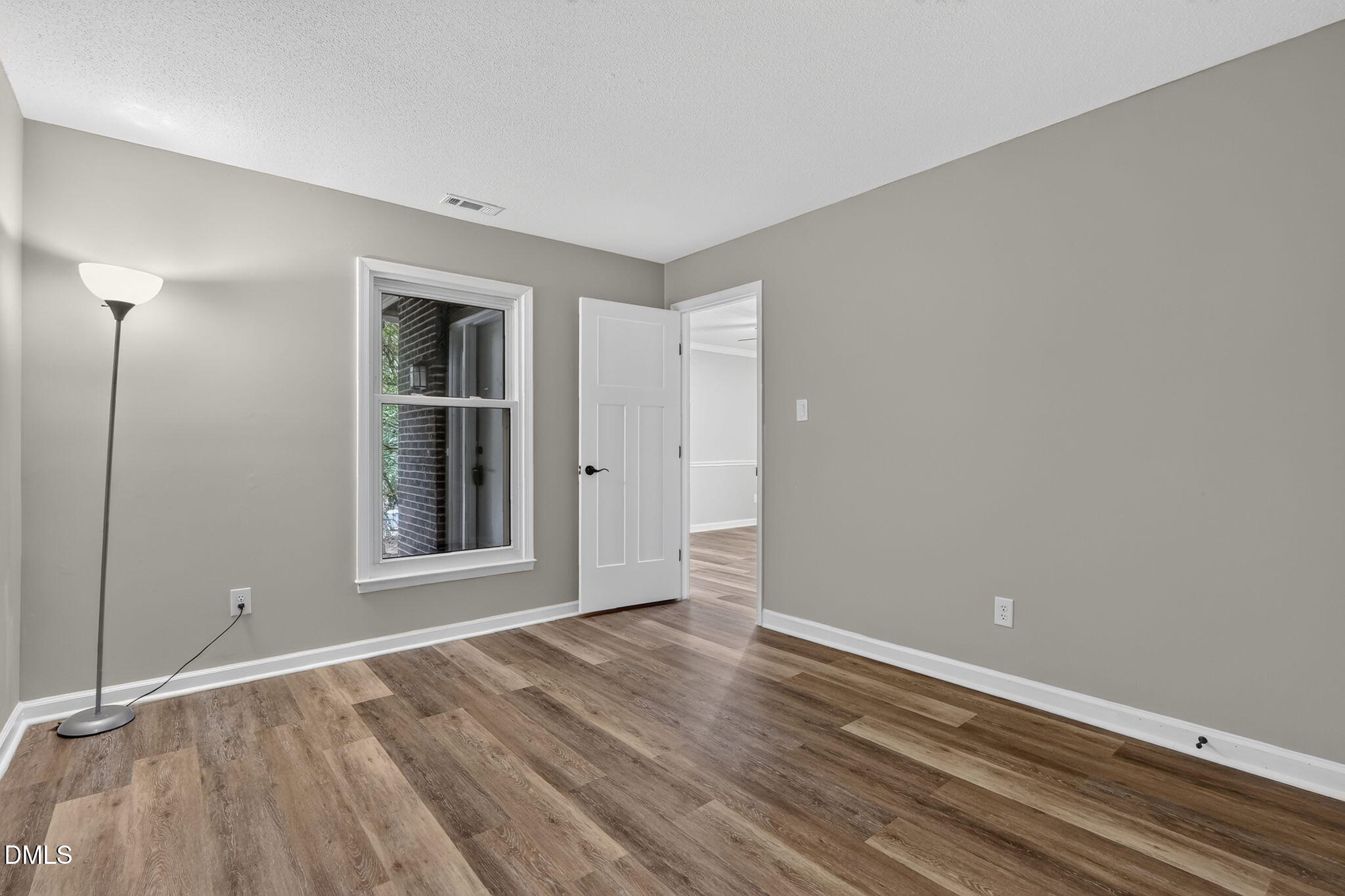 3425 Mill Run Raleigh, NC 27612 - Photo 21 of 40 a view of an empty room with wooden floor and a window