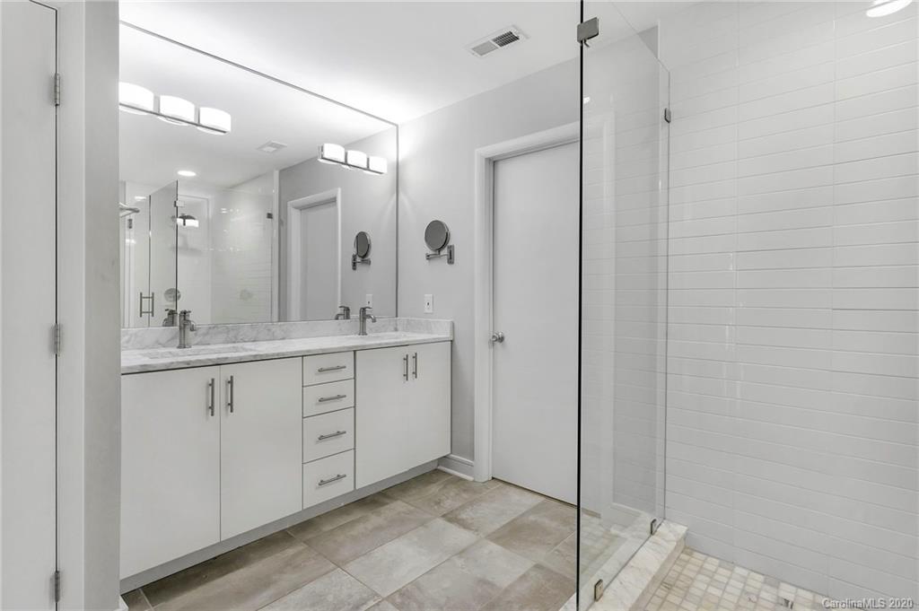 6200 Ropley Court Charlotte, NC 28211 - Photo 19 of 30 a spacious bathroom with a granite countertop sink mirror and shower