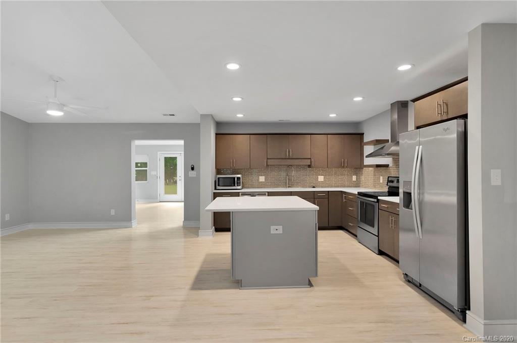 6200 Ropley Court Charlotte, NC 28211 - Photo 4 of 30 a large kitchen with stainless steel appliances kitchen island a large counter top and a refrigerator