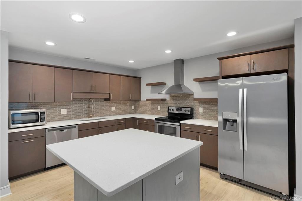 6200 Ropley Court Charlotte, NC 28211 - Photo 5 of 30 a kitchen with a refrigerator a sink and cabinets