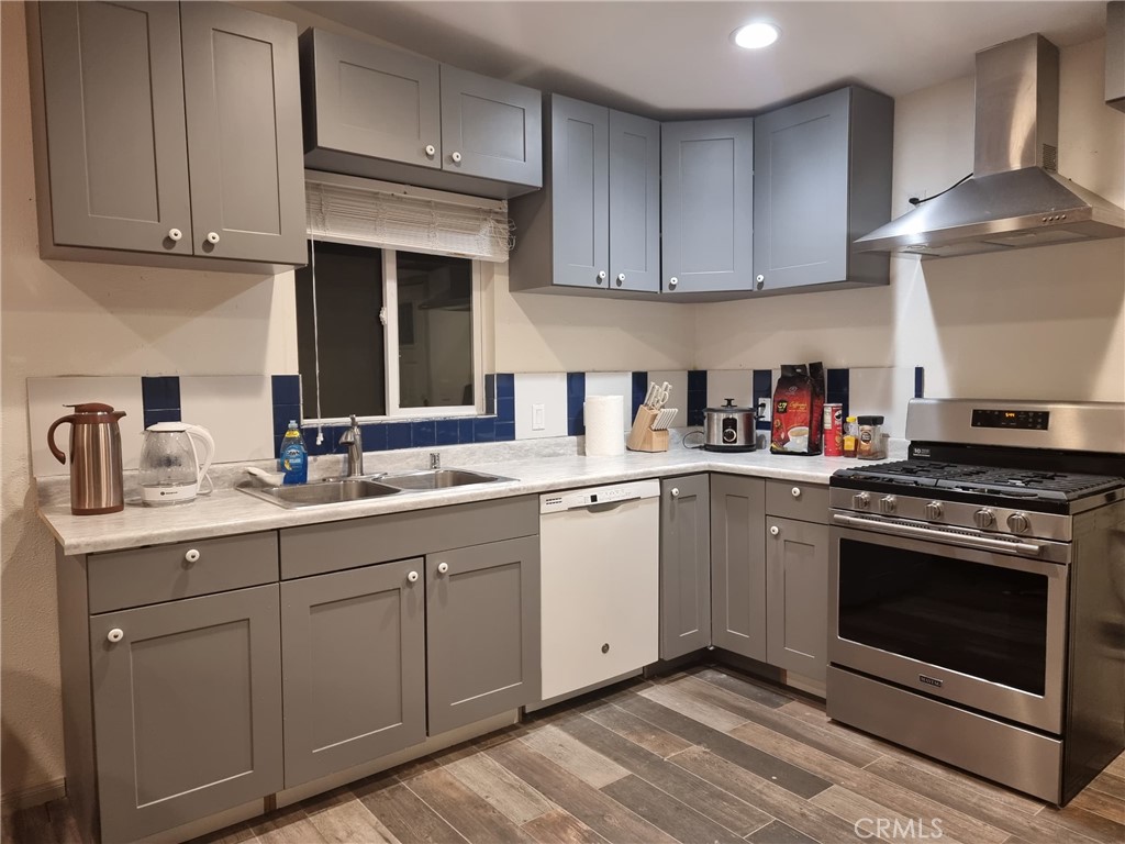 a kitchen with cabinets stainless steel appliances and a sink