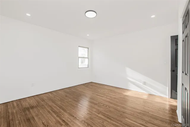 an empty room with wooden floor and closet