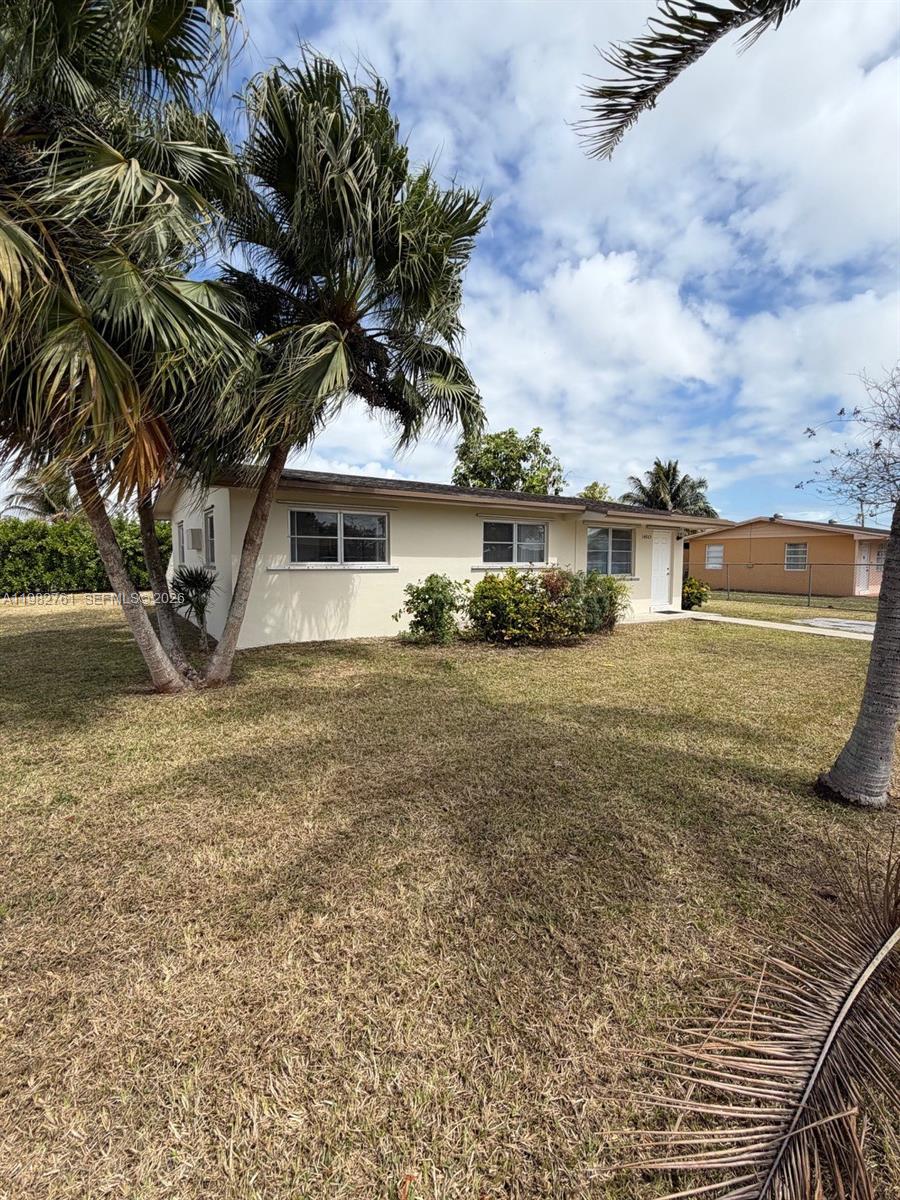14865 Southwest 302nd Street Homestead, FL 33033 - Photo 1 of 18 a front view of a house with a yard