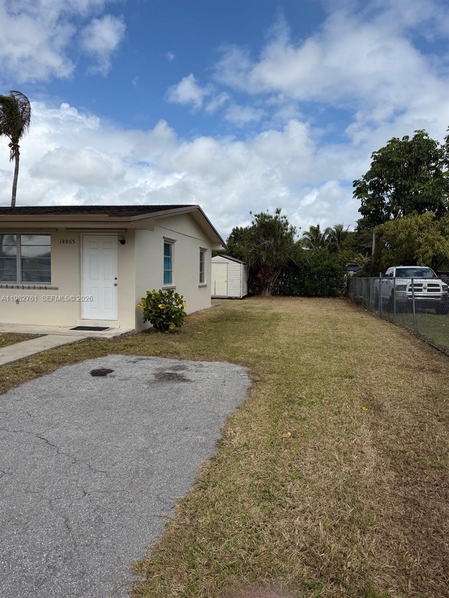 14865 Southwest 302nd Street Homestead, FL 33033 - Photo 5 of 18 a view of a house with a yard