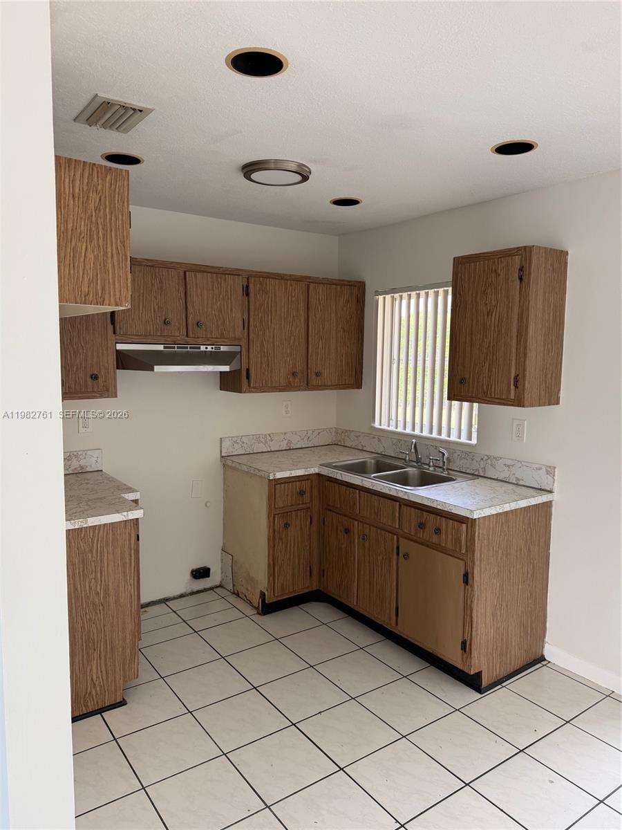 14865 Southwest 302nd Street Homestead, FL 33033 - Photo 8 of 18 a kitchen with cabinets and window