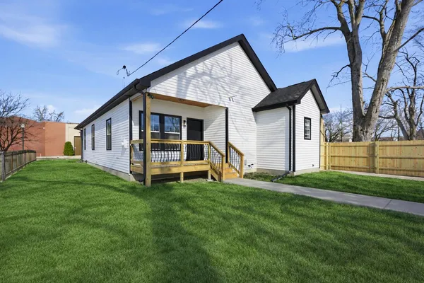 a view of a house with a yard and deck