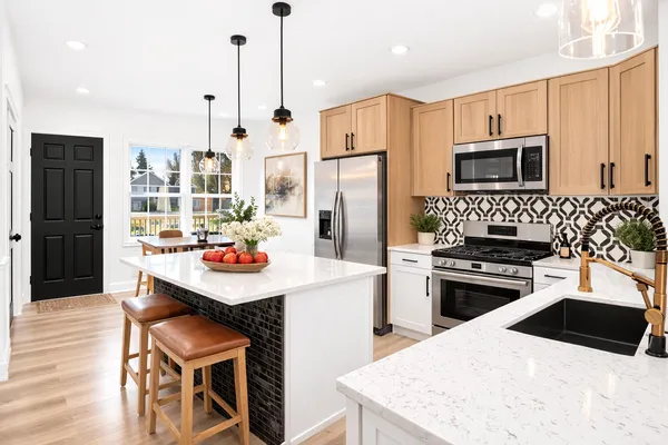 a kitchen with stainless steel appliances kitchen island granite countertop a stove a refrigerator a oven a sink with a dining table and chairs