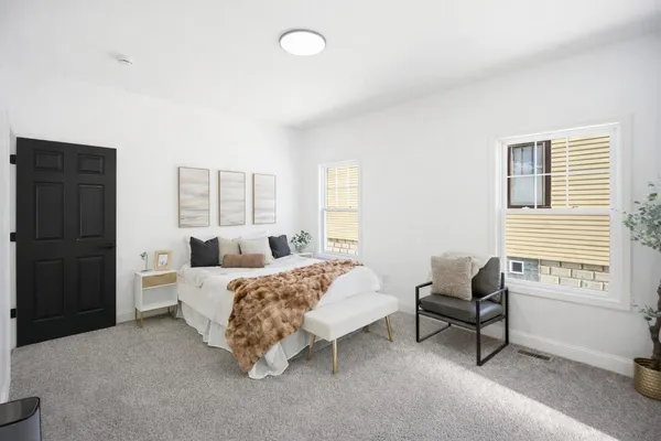 a bed room with a bed and a chair