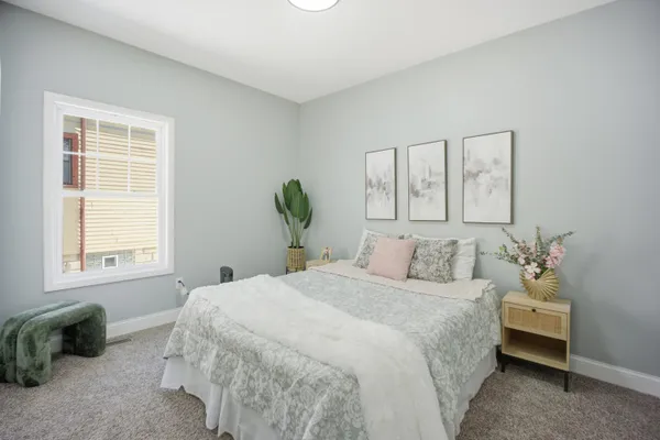 a bedroom with a bed and a window