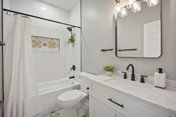 a bathroom with a sink a toilet and a mirror