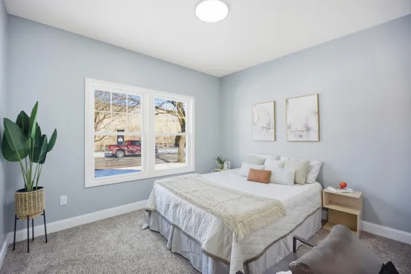 a bedroom with a large bed and a window