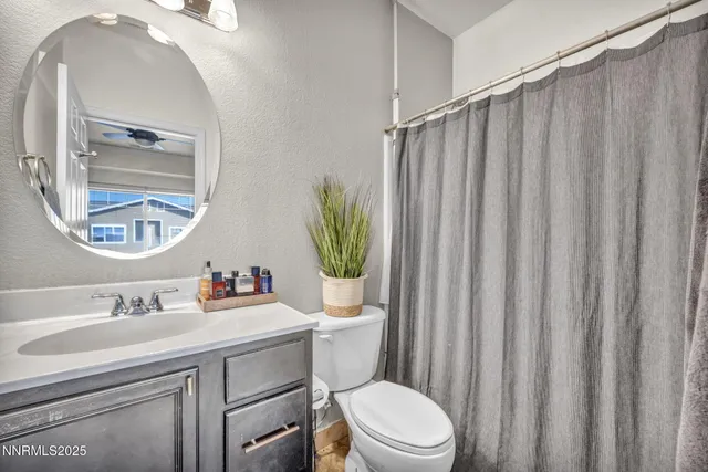 a bathroom with a toilet a sink and a mirror