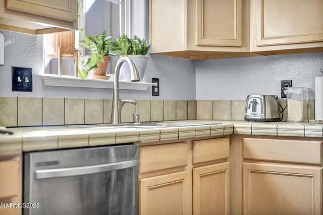 a kitchen with stainless steel appliances granite countertop a sink a stove and cabinets