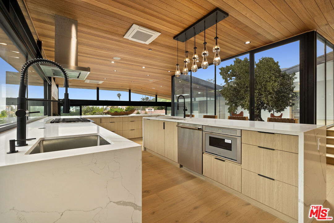 5707 Busch Drive Malibu, CA 90265 - Photo 11 of 35 a kitchen with a sink a stove and cabinets