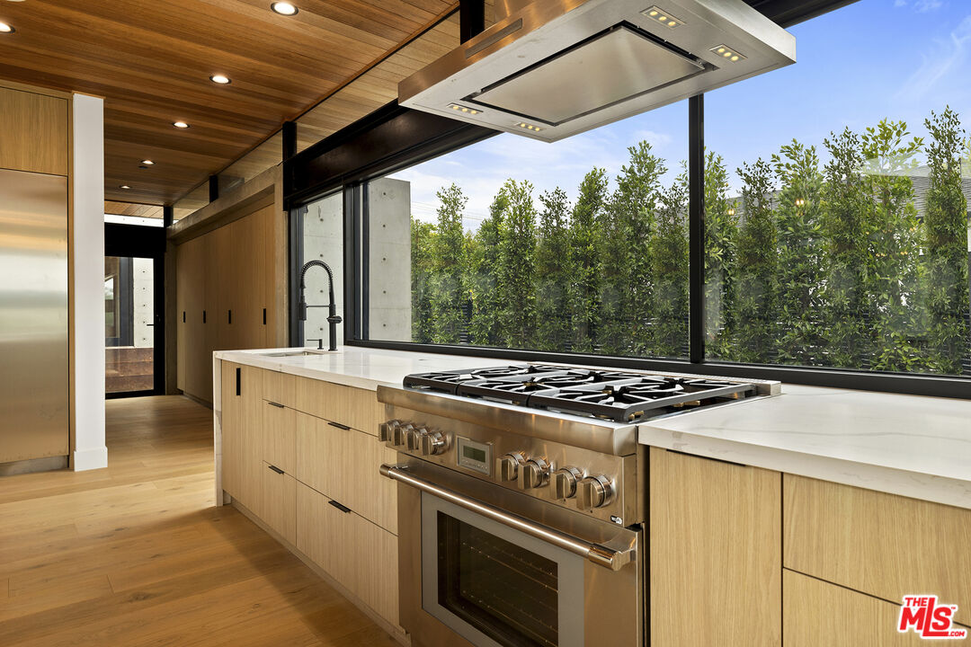 5707 Busch Drive Malibu, CA 90265 - Photo 12 of 35 a stove top oven sitting inside of a kitchen