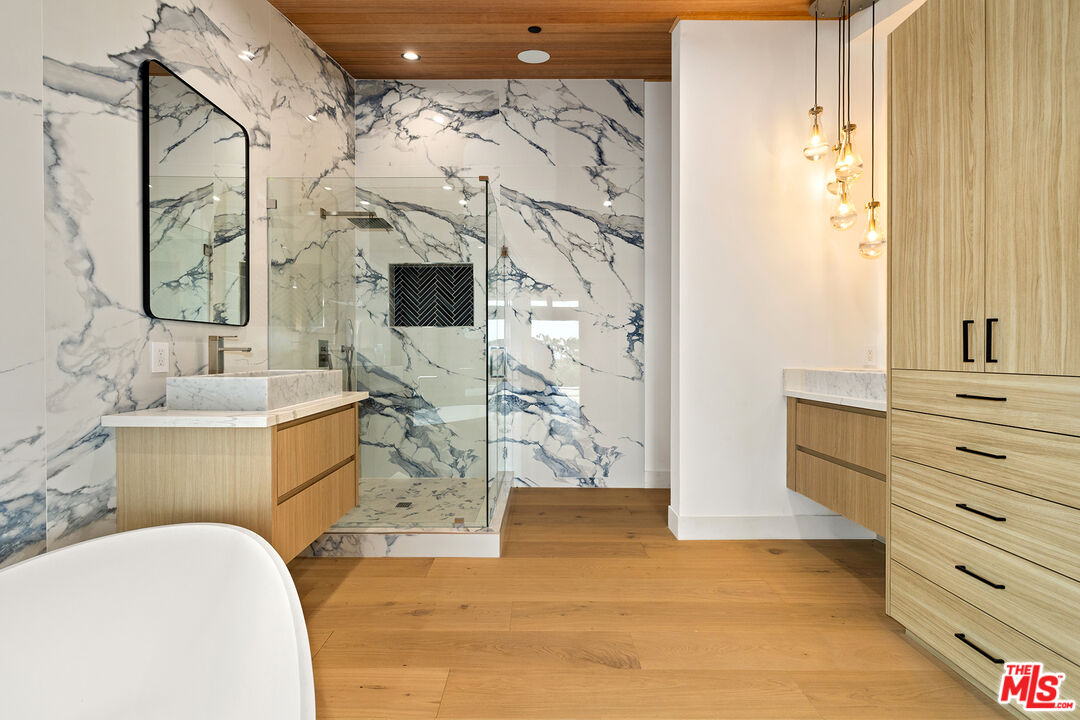 5707 Busch Drive Malibu, CA 90265 - Photo 18 of 35 a bathroom with a bathtub sink and mirror