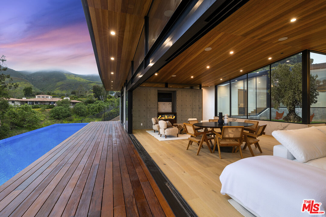 5707 Busch Drive Malibu, CA 90265 - Photo 30 of 35 a view of a patio with couches table and chairs and potted plants
