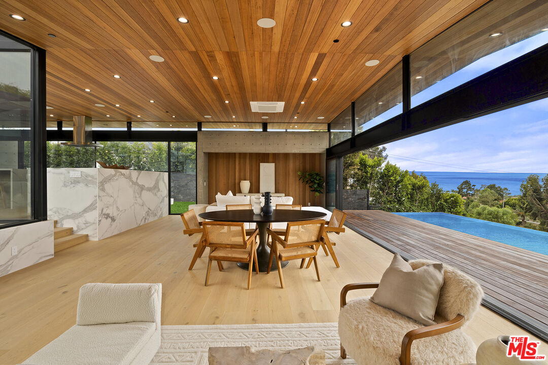 5707 Busch Drive Malibu, CA 90265 - Photo 3 of 35 a dining room with furniture and a garden