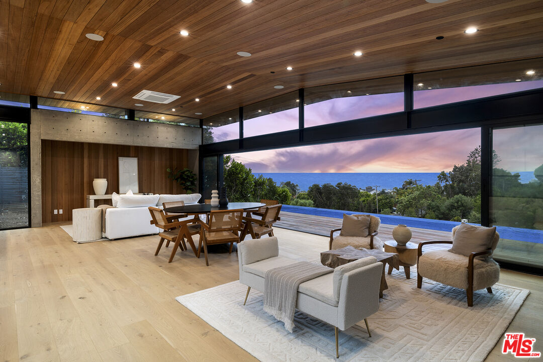 5707 Busch Drive Malibu, CA 90265 - Photo 32 of 35 a living room with patio furniture and a fireplace