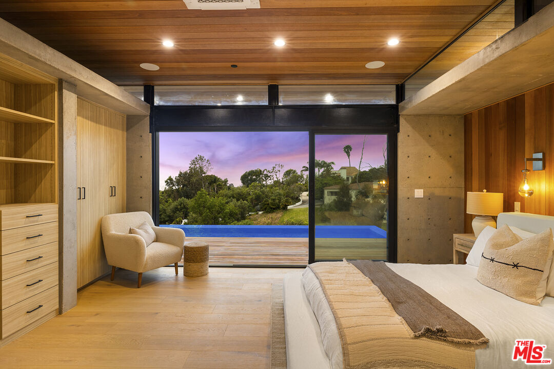 5707 Busch Drive Malibu, CA 90265 - Photo 33 of 35 a bedroom with furniture and a flat screen tv