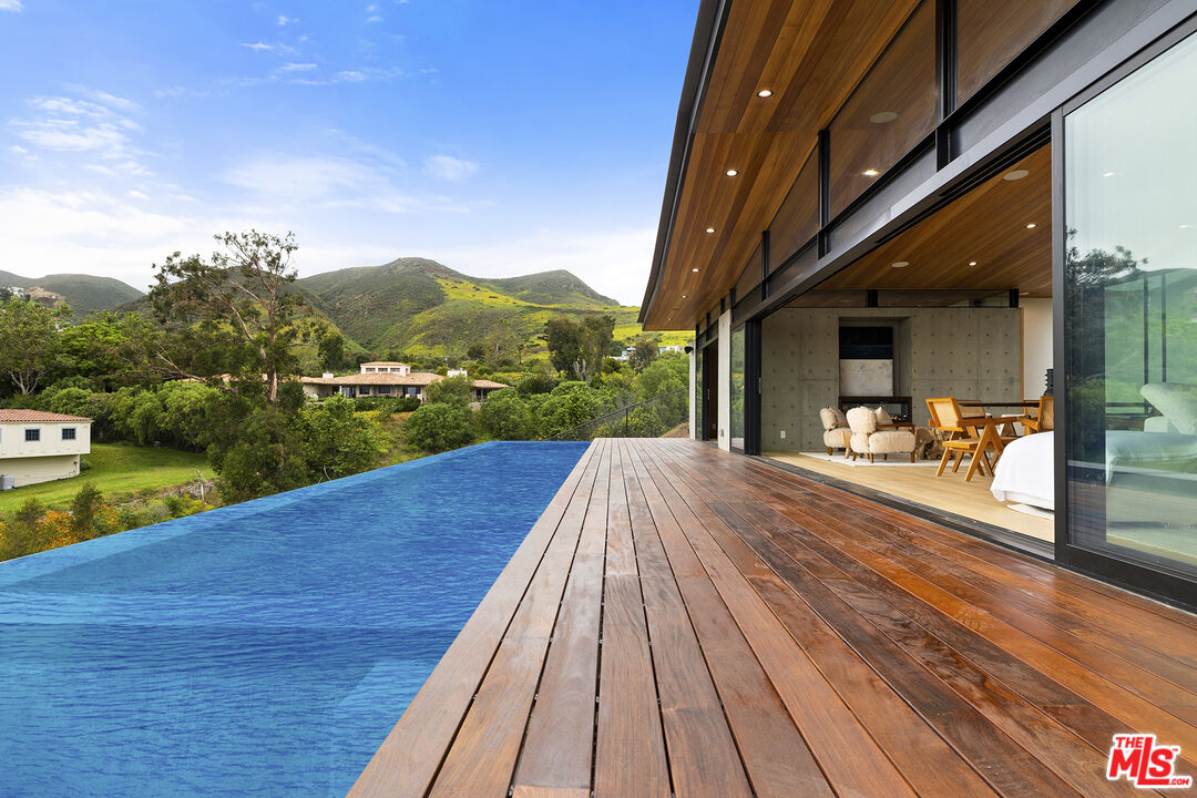 5707 Busch Drive Malibu, CA 90265 - Photo 5 of 35 a view of swimming pool with a patio