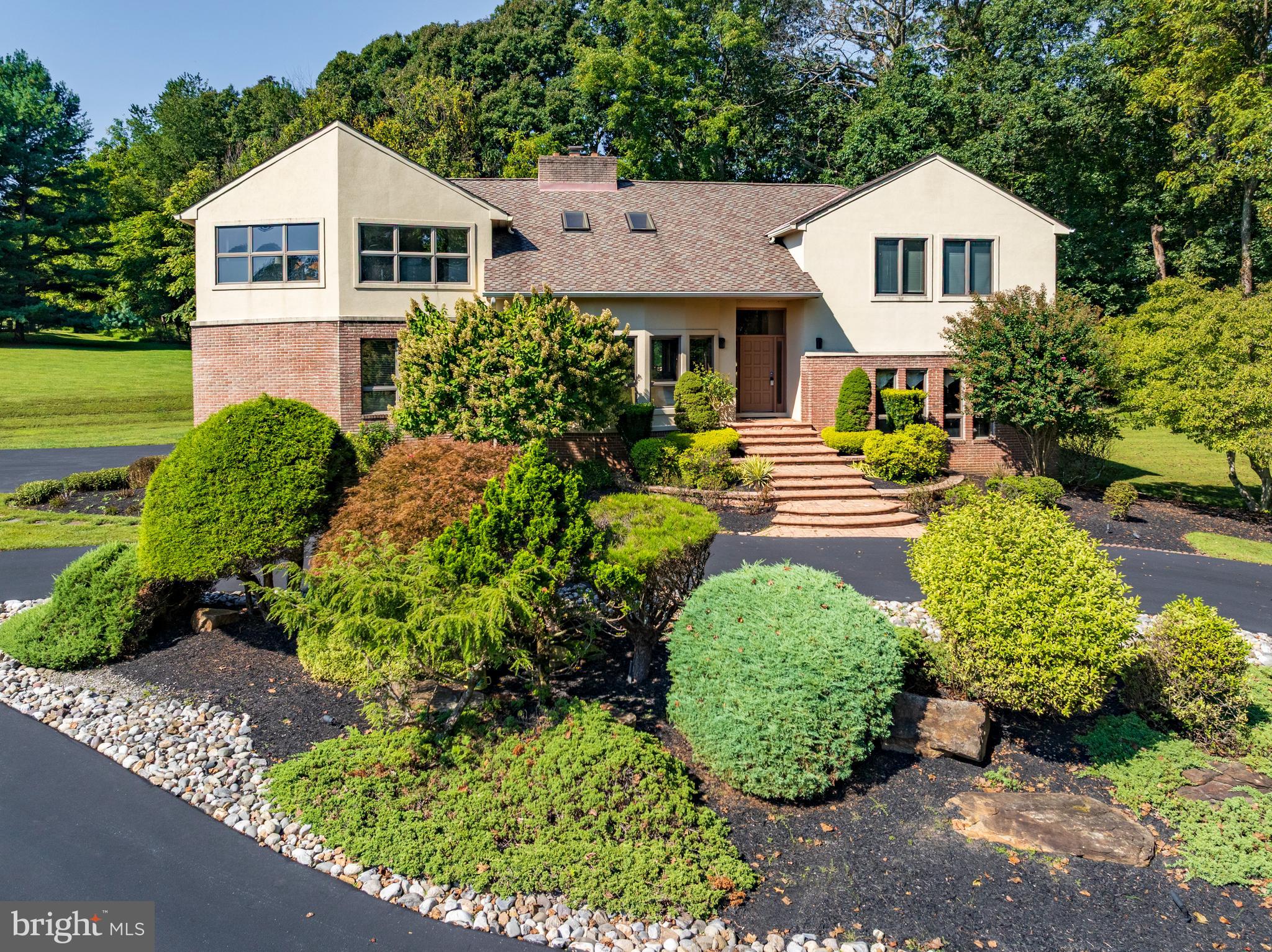 13304 Ridgewood Drive Ellicott City, MD 21042 - Photo 4 of 95 a front view of a house with a yard and potted plants