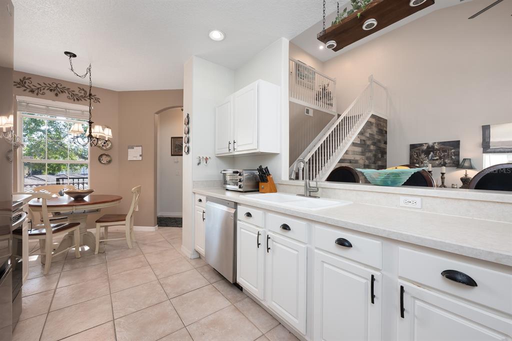 700 Seabrook Court, Unit 201 Altamonte Springs, FL 32714 - Photo 12 of 32 a kitchen with stainless steel appliances kitchen island granite countertop a sink and cabinets