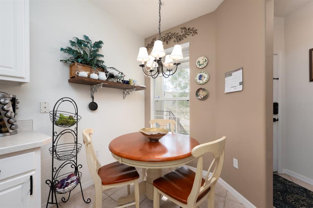 700 Seabrook Court, Unit 201 Altamonte Springs, FL 32714 - Photo 13 of 32 a table and a vase with flowers on a table