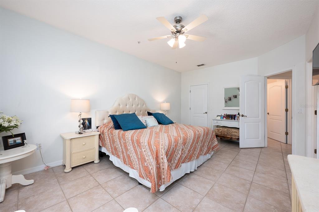 700 Seabrook Court, Unit 201 Altamonte Springs, FL 32714 - Photo 16 of 32 a bedroom with a bed and a chandelier