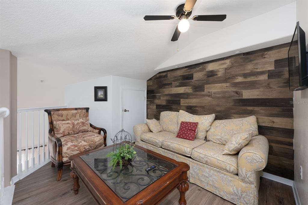 700 Seabrook Court, Unit 201 Altamonte Springs, FL 32714 - Photo 22 of 32 a living room with furniture and wooden floor