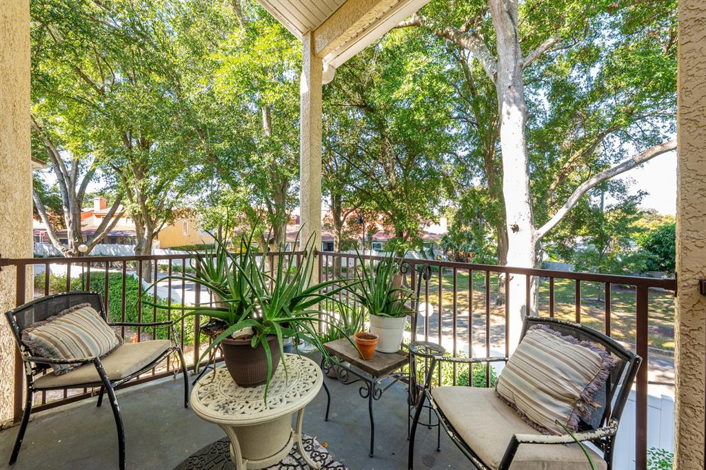 700 Seabrook Court, Unit 201 Altamonte Springs, FL 32714 - Photo 28 of 32 a view of a balcony with chairs and wooden floor