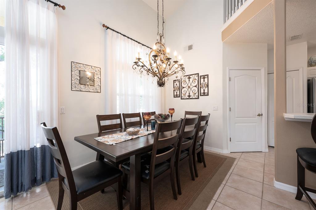 700 Seabrook Court, Unit 201 Altamonte Springs, FL 32714 - Photo 7 of 32 a view of a dining room with furniture and chandelier