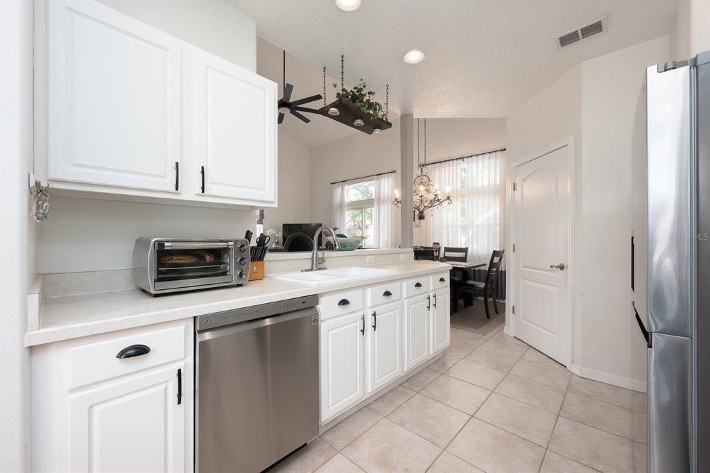 700 Seabrook Court, Unit 201 Altamonte Springs, FL 32714 - Photo 10 of 32 a kitchen with a sink and refrigerator