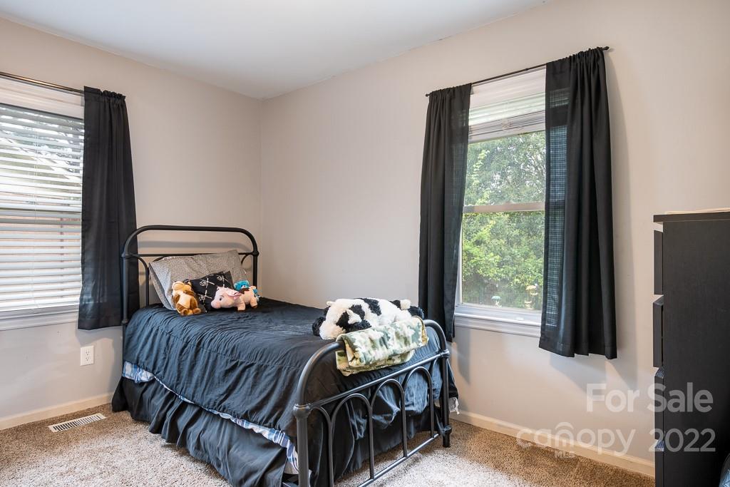 626 Westside Terrace, Unit 5 Davidson, NC 28036 - Photo 12 of 24 a bedroom with bed and a window