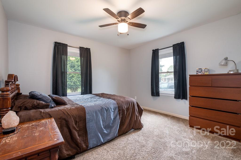 626 Westside Terrace, Unit 5 Davidson, NC 28036 - Photo 13 of 24 a bedroom with a bed and a window