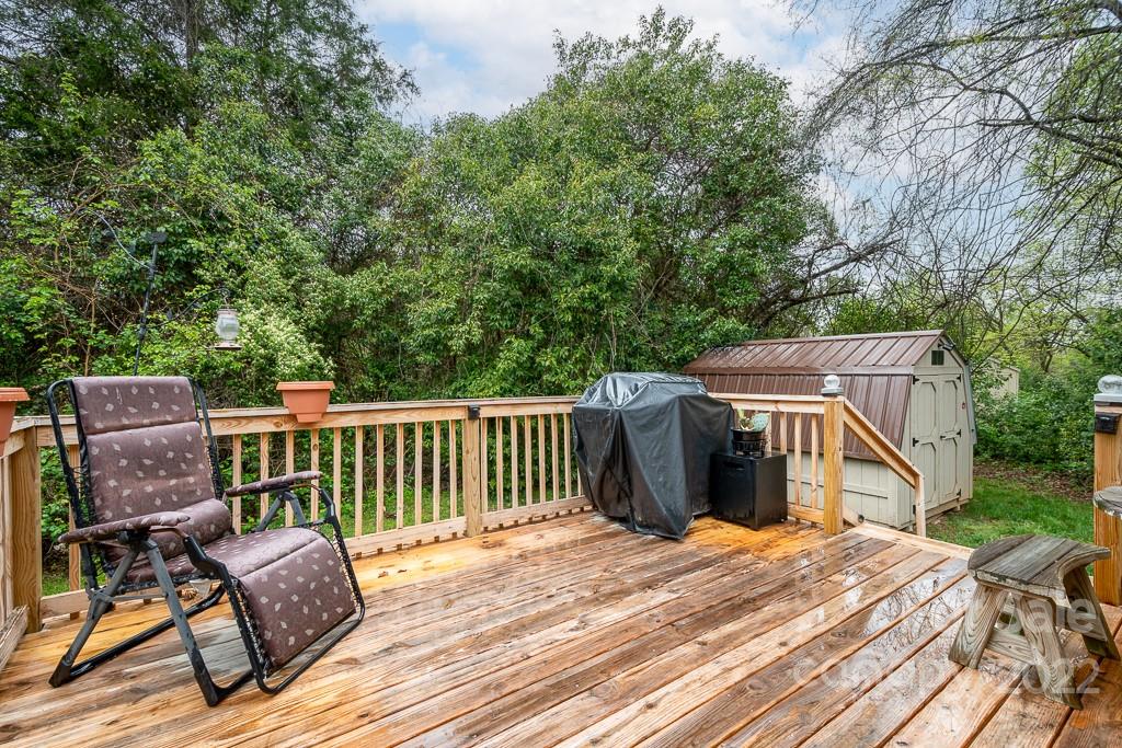 626 Westside Terrace, Unit 5 Davidson, NC 28036 - Photo 15 of 24 a view of a deck with chair and wooden floor