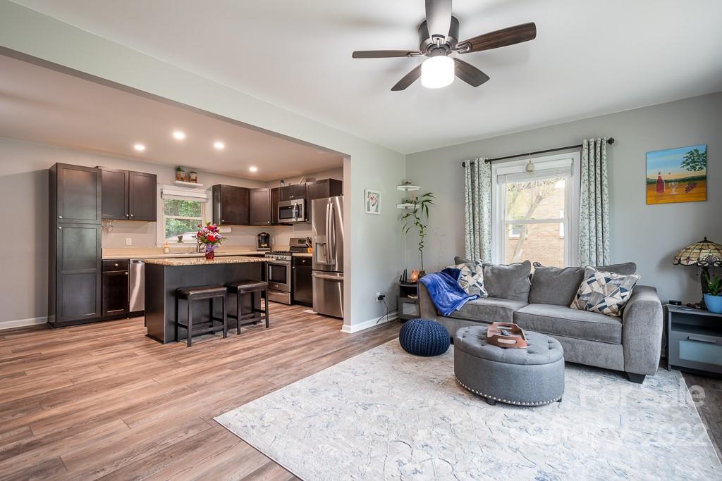 626 Westside Terrace, Unit 5 Davidson, NC 28036 - Photo 3 of 24 a living room with furniture and kitchen view