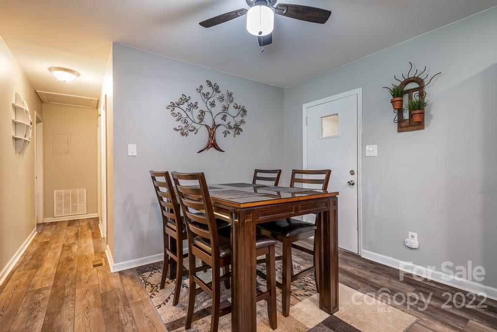 626 Westside Terrace, Unit 5 Davidson, NC 28036 - Photo 7 of 24 a view of a dining room with furniture and wooden floor