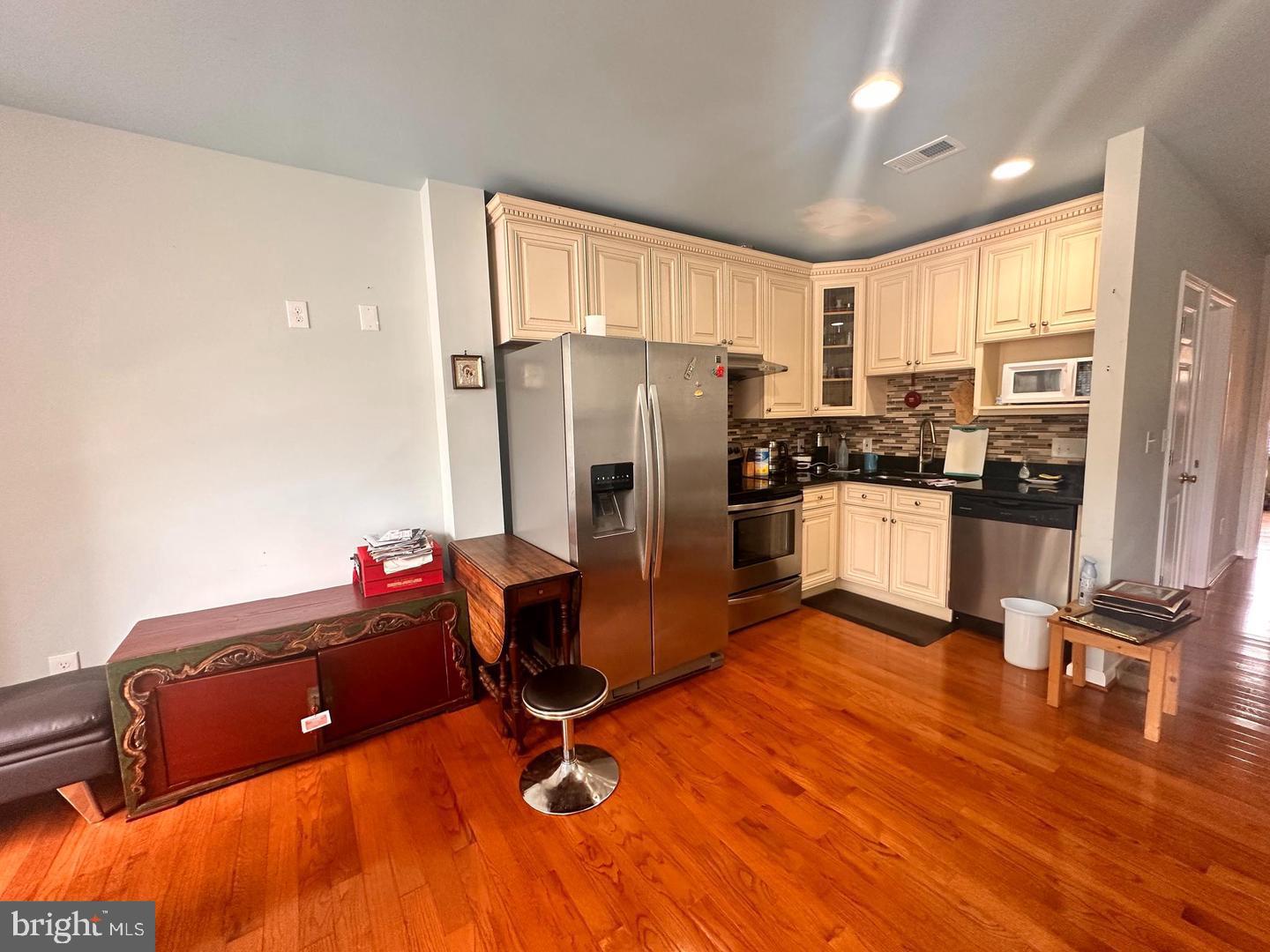 1658 33rd Street Northwest Washington, DC 20007 - Photo 1 of 5 a kitchen with stainless steel appliances granite countertop a refrigerator a stove top oven a sink island and chairs