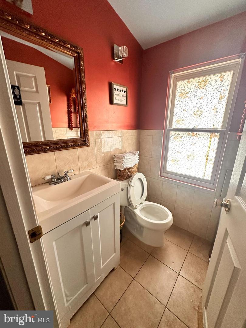 1658 33rd Street Northwest Washington, DC 20007 - Photo 5 of 5 a bathroom with a granite countertop toilet sink and mirror