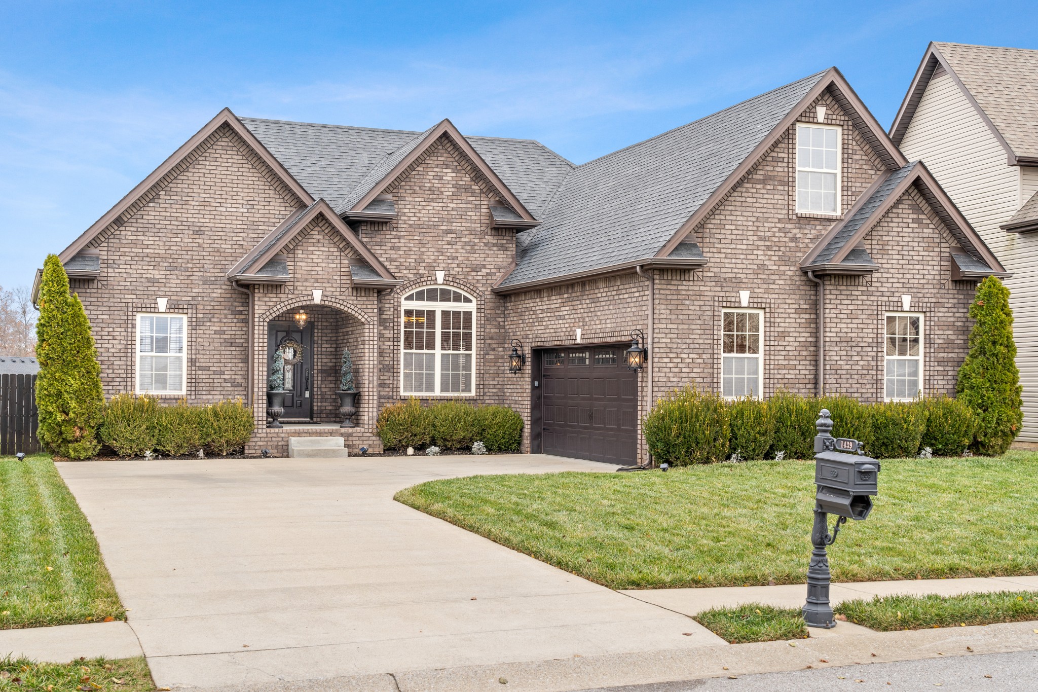 1439 Raven Road Clarksville, TN 37042 - Photo 1 of 28 a front view of a house with a yard and garage