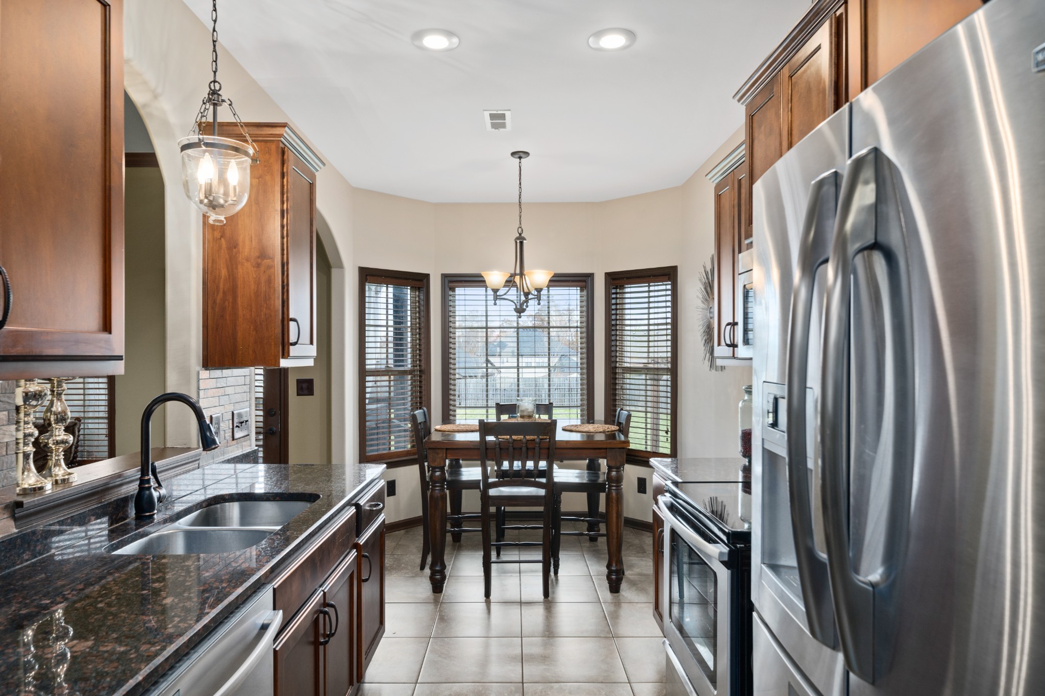1439 Raven Road Clarksville, TN 37042 - Photo 11 of 28 a kitchen with stainless steel appliances granite countertop a stove a sink and a refrigerator