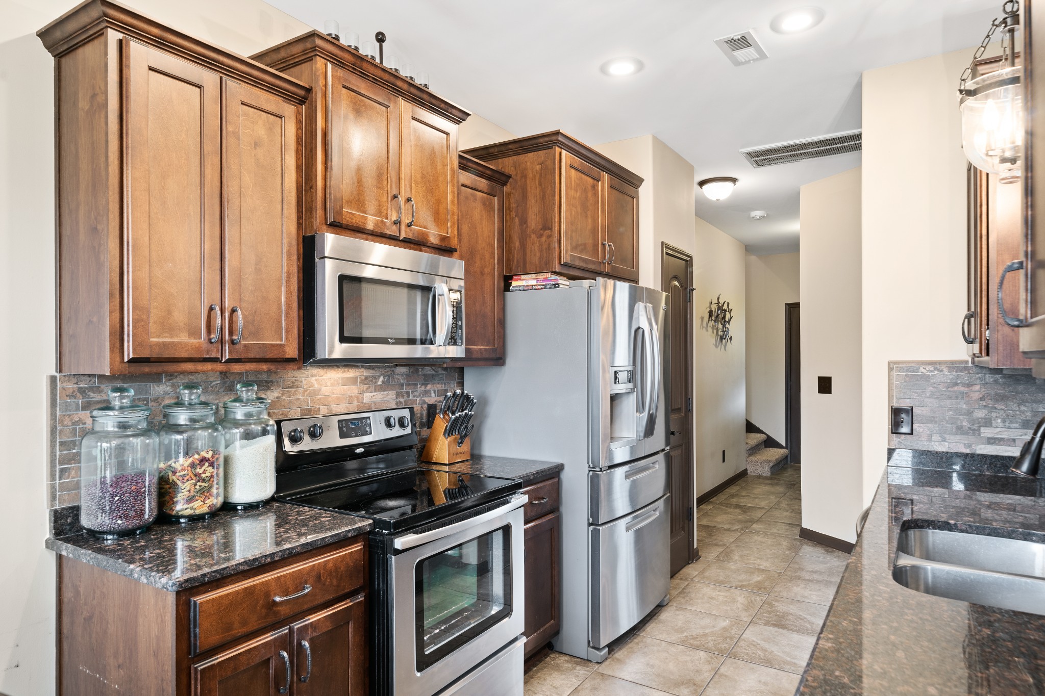1439 Raven Road Clarksville, TN 37042 - Photo 9 of 28 a kitchen with stainless steel appliances granite countertop a refrigerator stove and sink