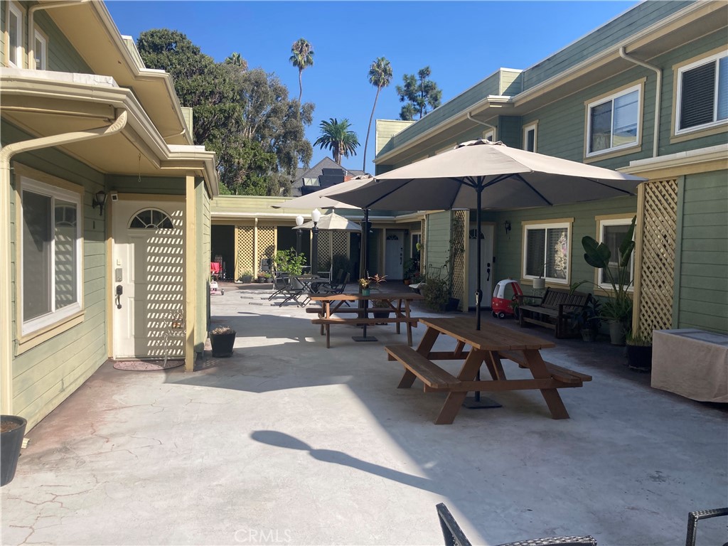 809 North Spurgeon Street, Unit 5 Santa Ana, CA 92701 - Photo 3 of 12 a view of a patio with a table and chairs under an umbrella