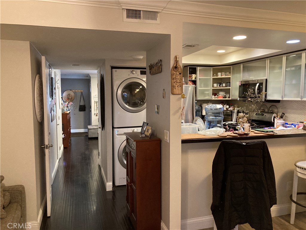 809 North Spurgeon Street, Unit 5 Santa Ana, CA 92701 - Photo 5 of 12 a kitchen with stainless steel appliances a refrigerator a sink a stove top oven with wooden floor