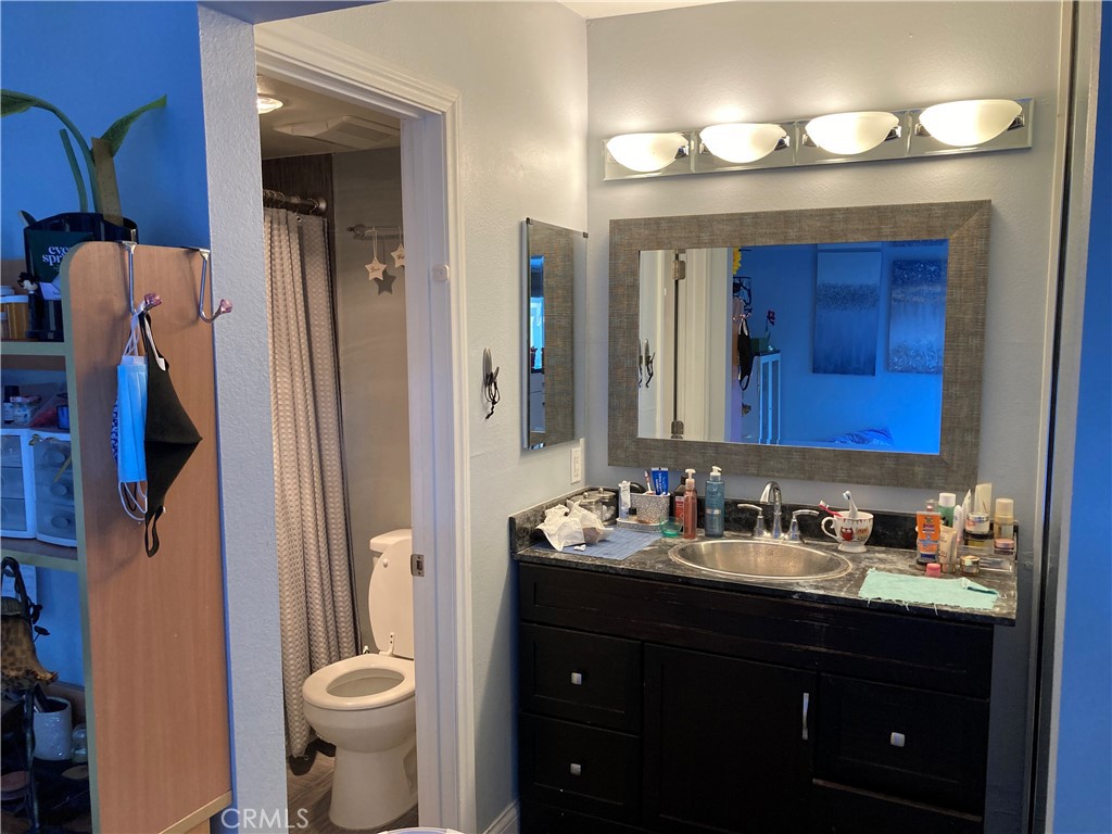 809 North Spurgeon Street, Unit 5 Santa Ana, CA 92701 - Photo 8 of 12 a bathroom with a sink vanity and a mirror